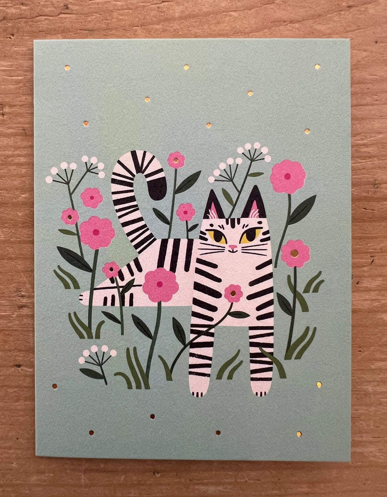 Cat among the flowers green